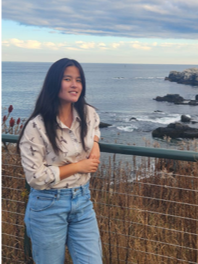 Hannah is an Asian woman with long black hair and a slight smile